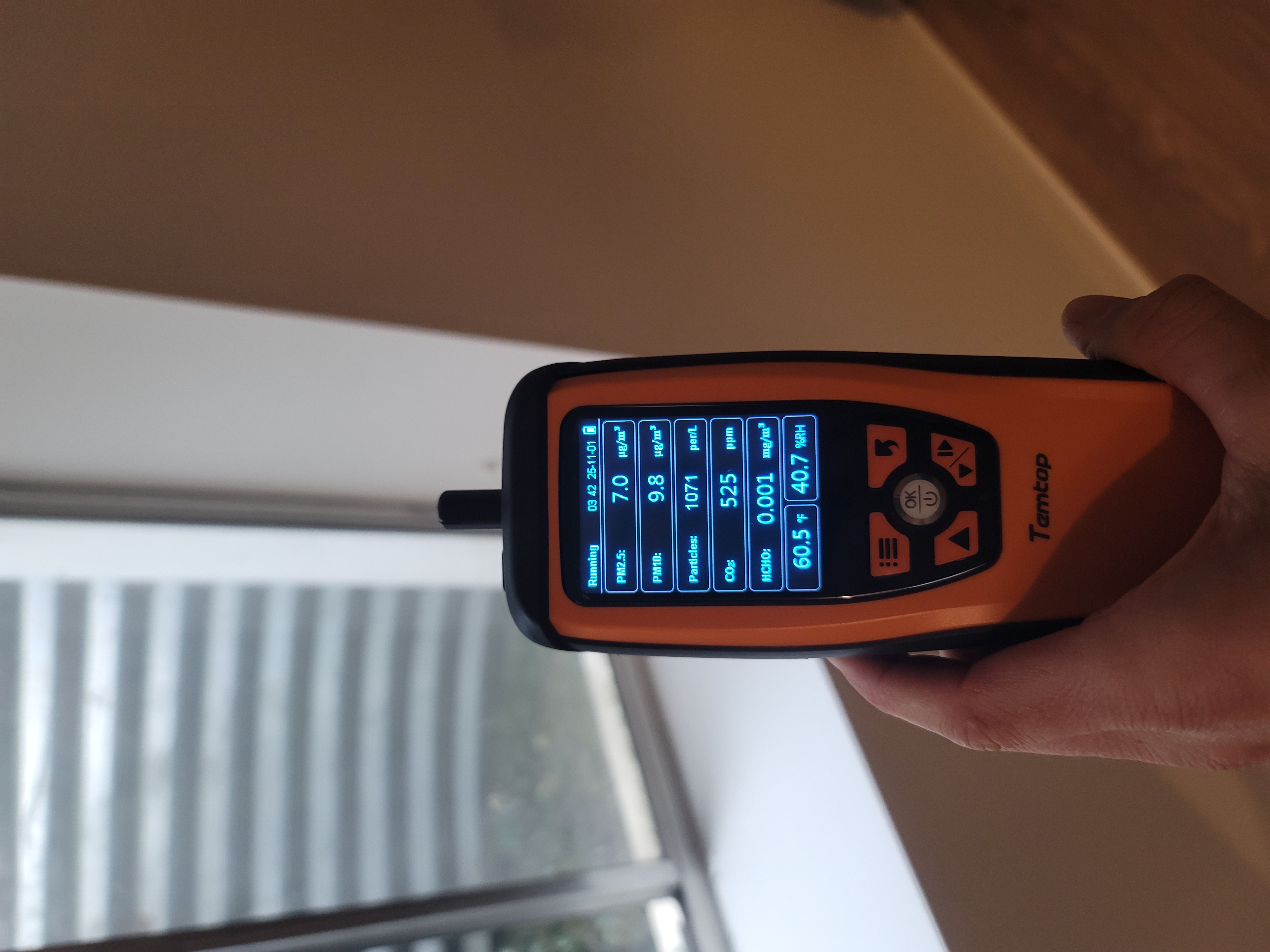 Professional air quality testing equipment measuring particle levels in South Florida residence